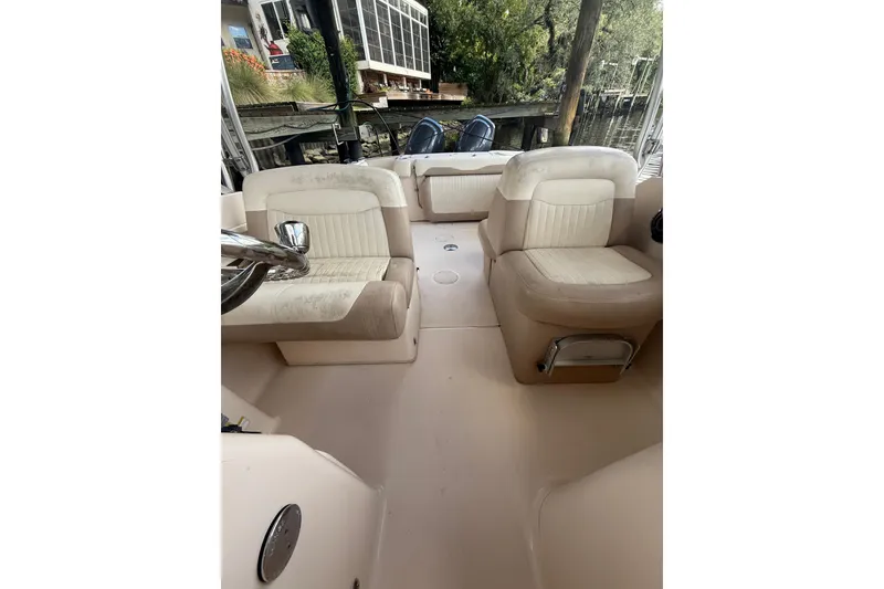 Slide: The Image of 2014 Grady-White Freedom 275 boat interior with beige seating and steering wheel. - 56