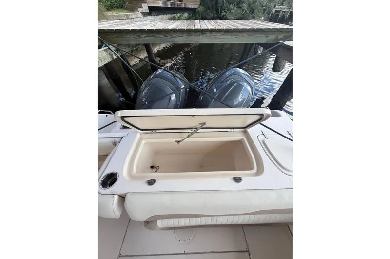 Slide: The Image of 2014 Grady-White Freedom 275 boat with open storage compartment and dual engines. - 60
