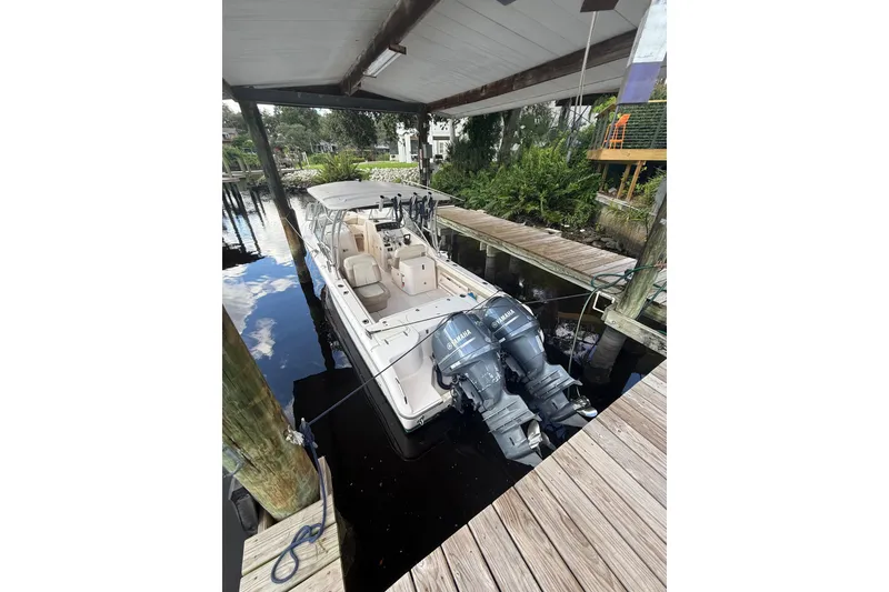 Slide: The Image of 2014 Grady-White Freedom 275 boat docked with dual Yamaha engines. - 67