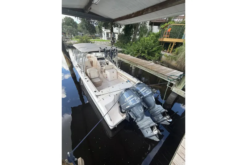 Slide: The Image of 2014 Grady-White Freedom 275 boat docked with dual Yamaha engines. - 68