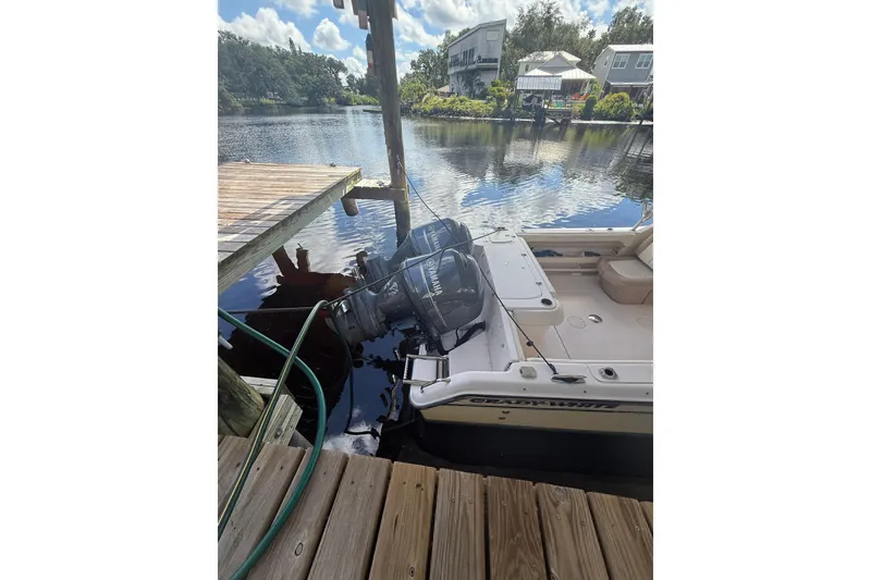 Slide: The Image of 2014 Grady-White Freedom 275 boat docked by a scenic waterfront. - 7