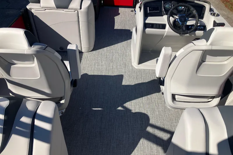 Slide: The Image of 2026 Tahoe Pontoon LTZ Quad Lounger interior with modern seating and steering console. - 18