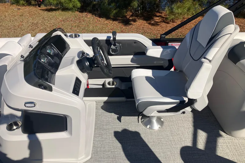 Slide: The Image of 2026 Tahoe Pontoon LTZ Quad Lounger helm with modern steering and comfortable seating. - 19