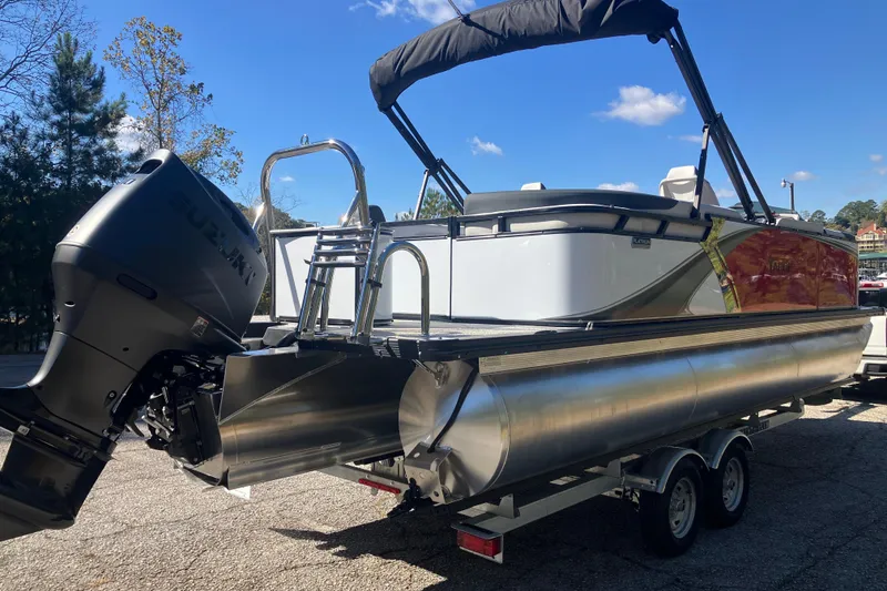 Slide: The Image of 2026 Tahoe Pontoon LTZ Quad Lounger on trailer, featuring Suzuki outboard motor. - 5