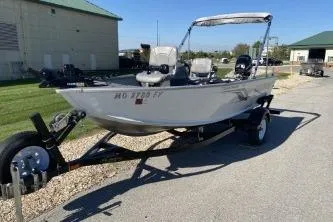 Slide: The Image of 2013 Crestliner Fisherman 145 CS boat on trailer, parked outdoors. - 2