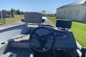 Slide: The Image of 2013 Crestliner Fisherman 145 CS boat interior with steering wheel and control panel. - 3