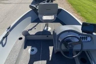 Slide: The Image of 2013 Crestliner Fisherman 145 CS boat interior with steering wheel and seating. - 4