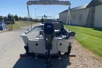 Slide: The Image of 2013 Crestliner Fisherman 145 CS boat with outboard motor, parked on a sunny day. - 6