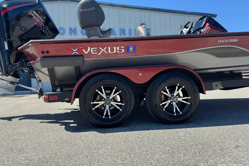 Slide: The Image of 2019 Vexus AVX2080 boat with dual axle trailer, parked outdoors. - 10