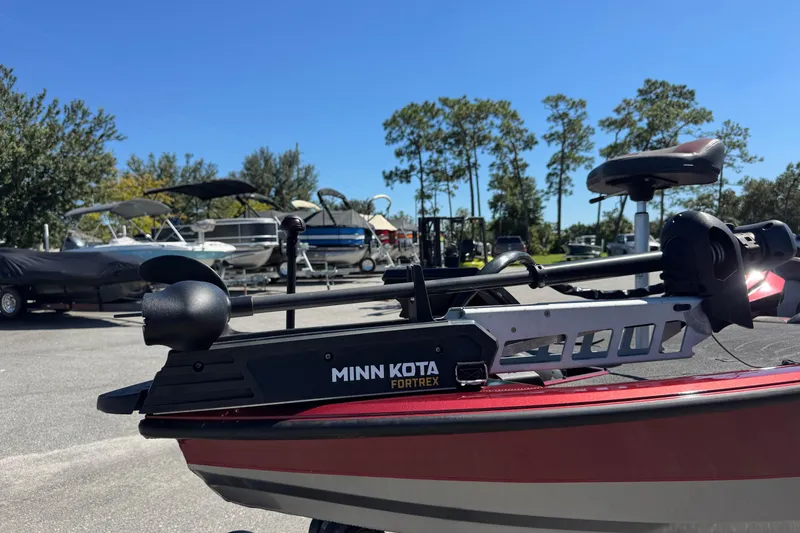 Slide: The Image of 2019 Vexus AVX2080 boat with Minn Kota Fortrex motor in a marina setting. - 13