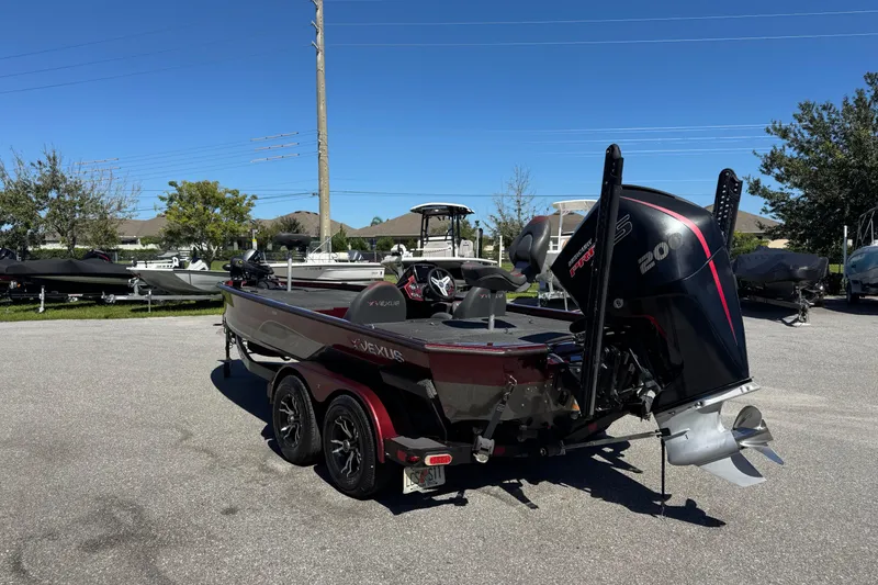 Slide: The Image of 2019 Vexus AVX2080 boat with powerful outboard motor, parked outdoors on a sunny day. - 7