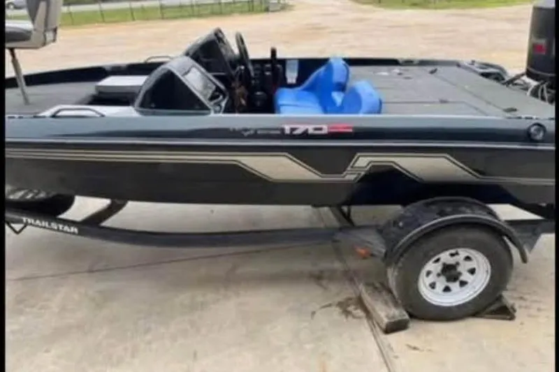 Slide: The Image of 1997 Nitro 170 DC boat on trailer, featuring sleek design and blue seating. - 3