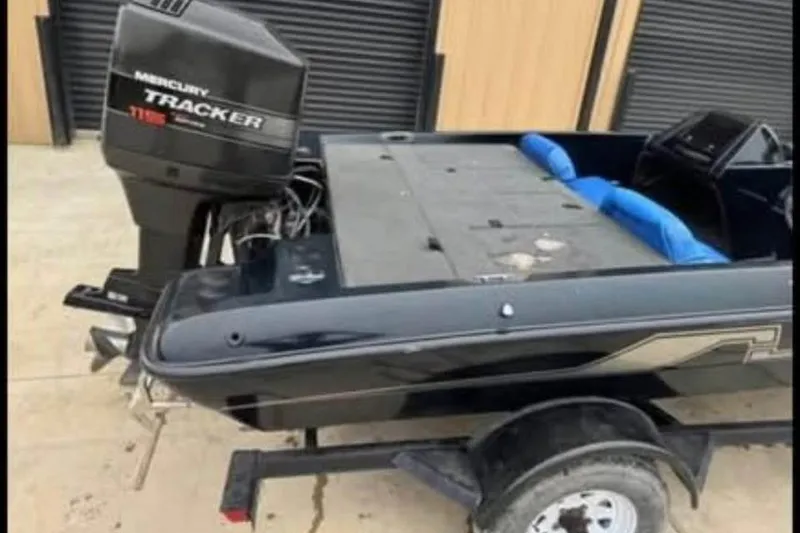Slide: The Image of 1997 Nitro 170 DC boat with Mercury Tracker engine, parked on a trailer. - 5
