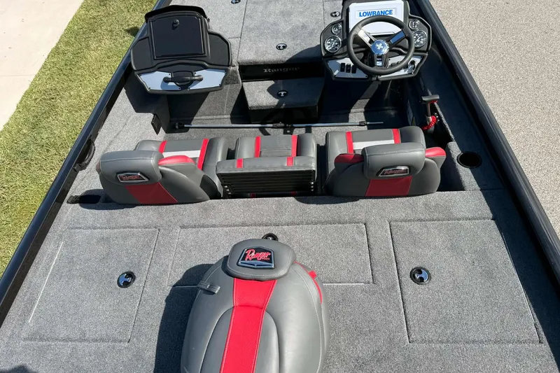 Slide: The Image of 2025 Ranger RT198P boat interior with gray and red seating, steering wheel, and storage compartments. - 5