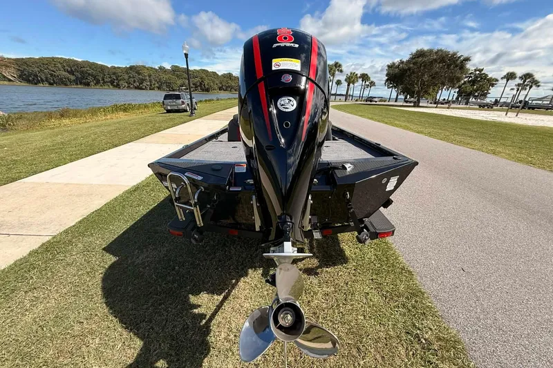 Slide: The Image of 2025 Ranger RT198P boat with outboard motor, parked near a scenic lakeside path. - 6