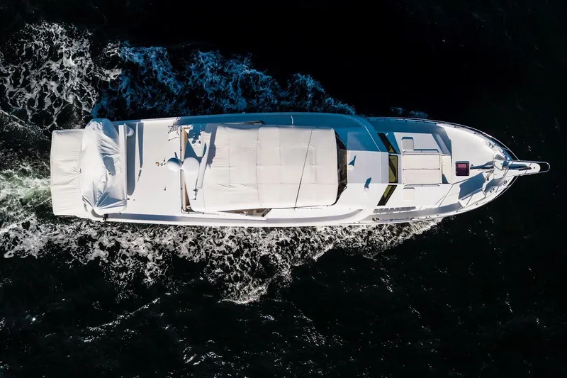 Slide: The Image of Aerial view of 2000 Hatteras 74 Cockpit Motor Yacht cruising on dark water. - 12