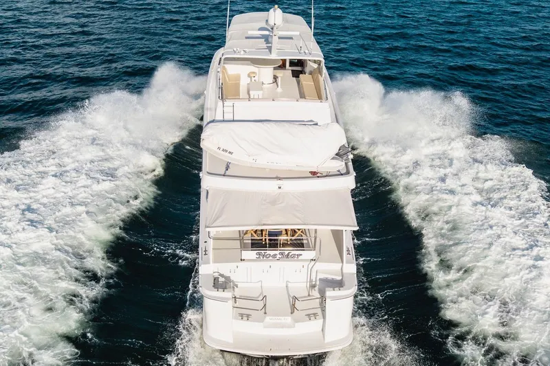 Slide: The Image of Hatteras 74 Cockpit Motor Yacht 2000 cruising on open water, rear view. - 13