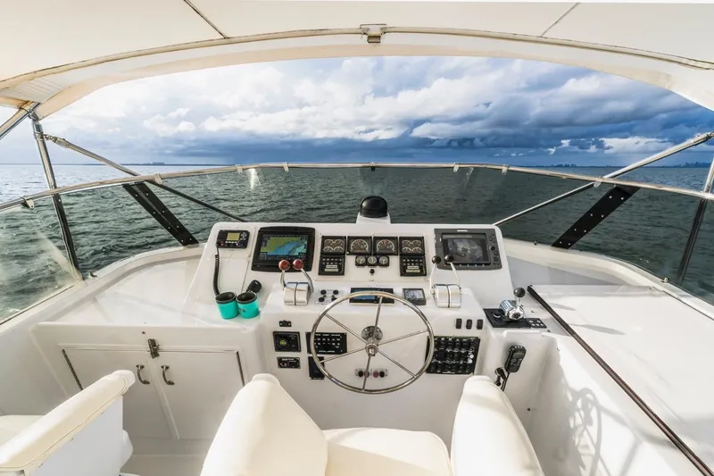 Slide: The Image of Cockpit view of 2000 Hatteras 74 Cockpit Motor Yacht with ocean and cloudy sky. - 14