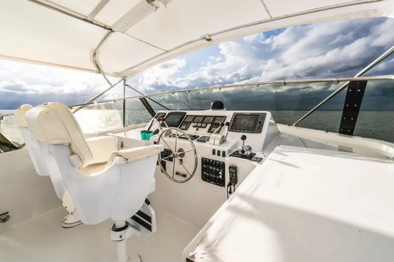 Slide: The Image of Cockpit of 2000 Hatteras 74 Cockpit Motor Yacht with ocean view and modern controls. - 15