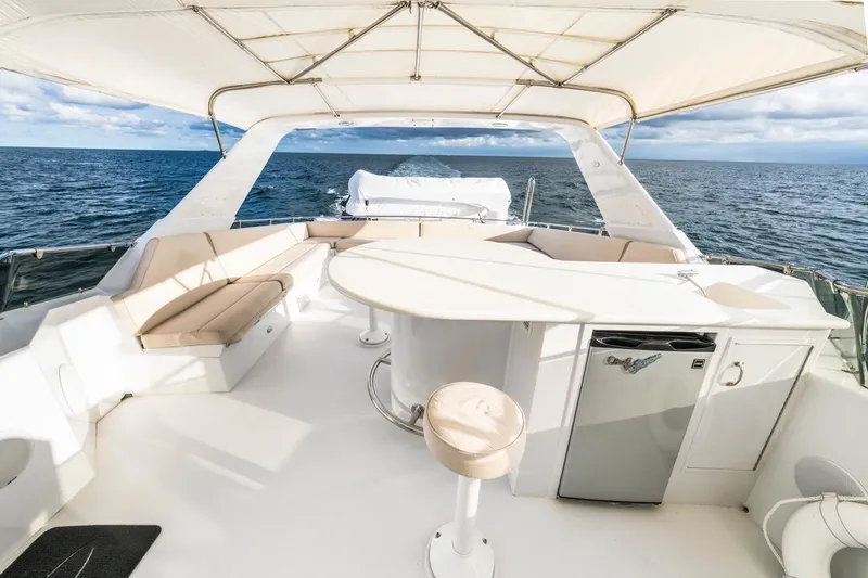 Slide: The Image of Luxurious 2000 Hatteras 74 Cockpit Motor Yacht with spacious seating and ocean view. - 17