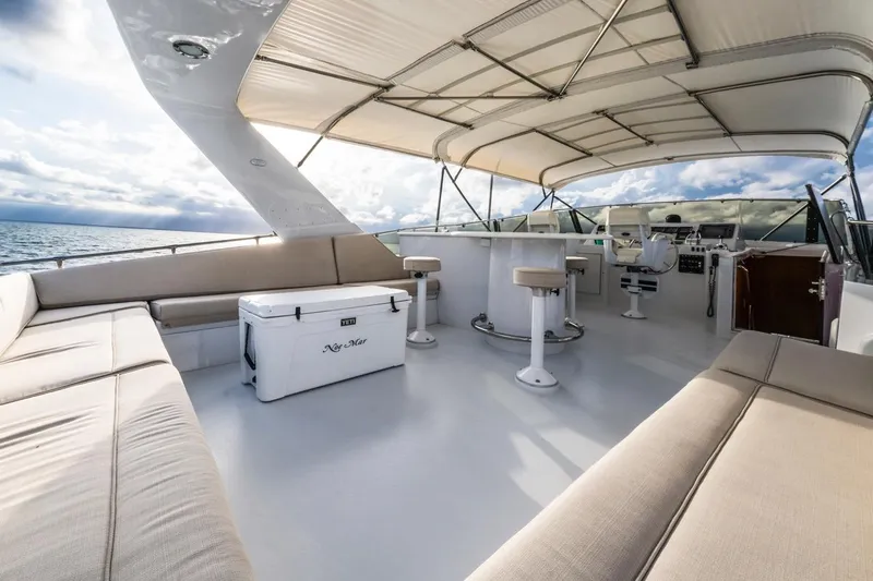 Slide: The Image of Luxurious 2000 Hatteras 74 Cockpit Motor Yacht with spacious deck and seating area. - 18