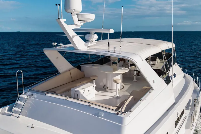 Slide: The Image of Luxury 2000 Hatteras 74 Cockpit Motor Yacht on open sea, featuring spacious deck. - 21