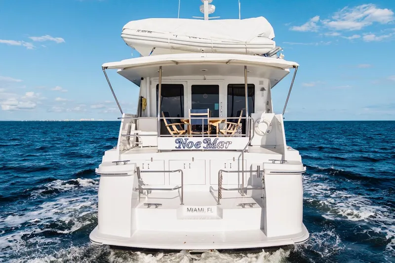 Slide: The Image of Rear view of 2000 Hatteras 74 Cockpit Motor Yacht cruising on open sea. - 23