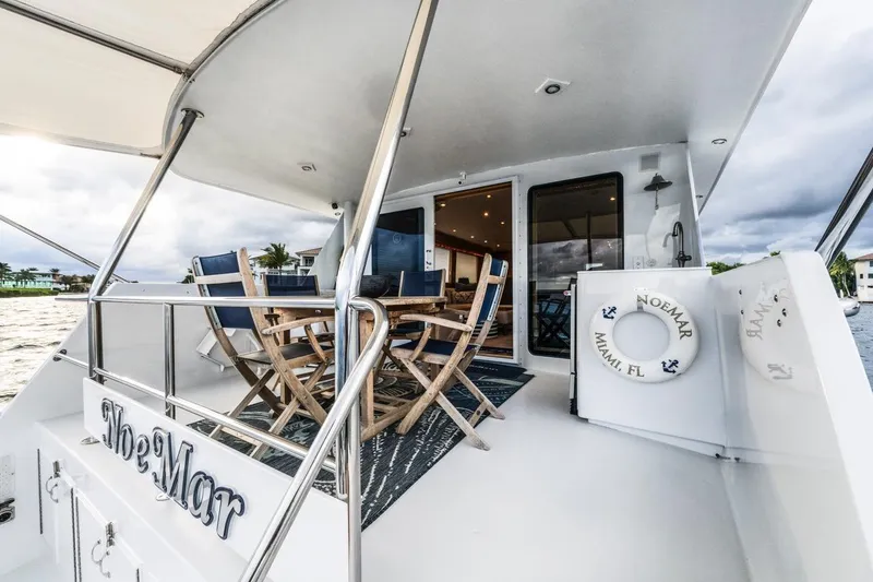 Slide: The Image of Luxurious 2000 Hatteras 74 Cockpit Motor Yacht with outdoor seating and ocean view. - 26