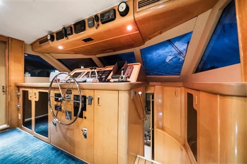 Slide: The Image of Cockpit of 2000 Hatteras 74 Cockpit Motor Yacht with wooden interior and navigation instruments. - 28