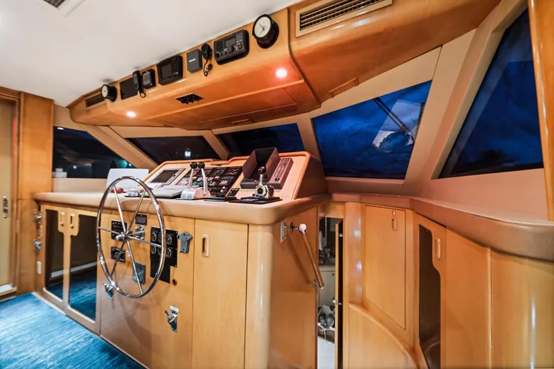 Slide: The Image of Cockpit of 2000 Hatteras 74 Cockpit Motor Yacht with steering wheel and control panels. - 29