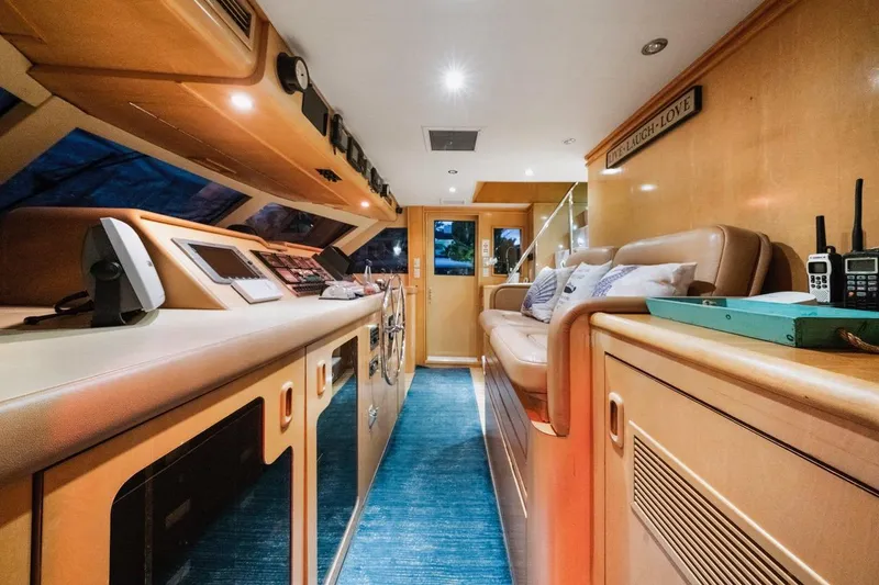 Slide: The Image of Interior of 2000 Hatteras 74 Cockpit Motor Yacht, featuring luxurious seating and navigation equipment. - 32
