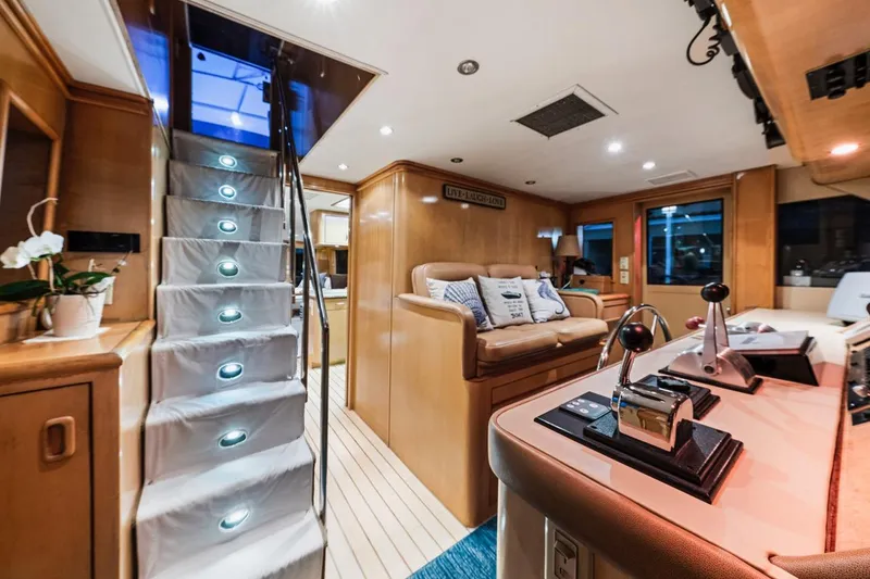 Slide: The Image of Luxurious interior of 2000 Hatteras 74 Cockpit Motor Yacht with modern helm and cozy seating. - 33