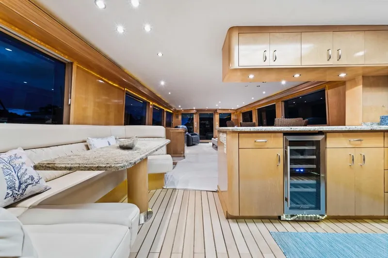 Slide: The Image of Luxurious interior of 2000 Hatteras 74 Cockpit Motor Yacht with elegant seating and modern kitchen. - 37