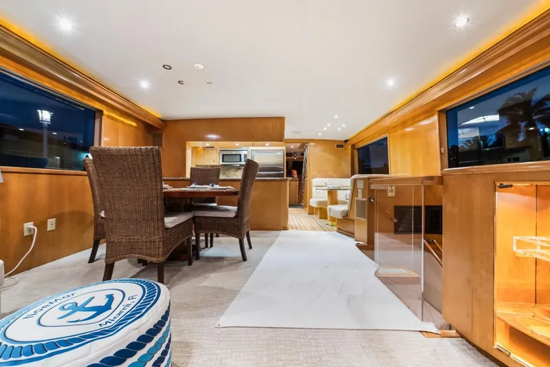 Slide: The Image of Luxurious interior of 2000 Hatteras 74 Cockpit Motor Yacht with elegant dining area. - 38