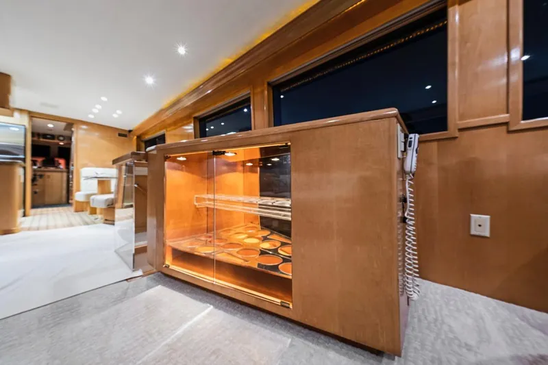 Slide: The Image of Luxurious interior of 2000 Hatteras 74 Cockpit Motor Yacht with elegant wood cabinetry. - 40