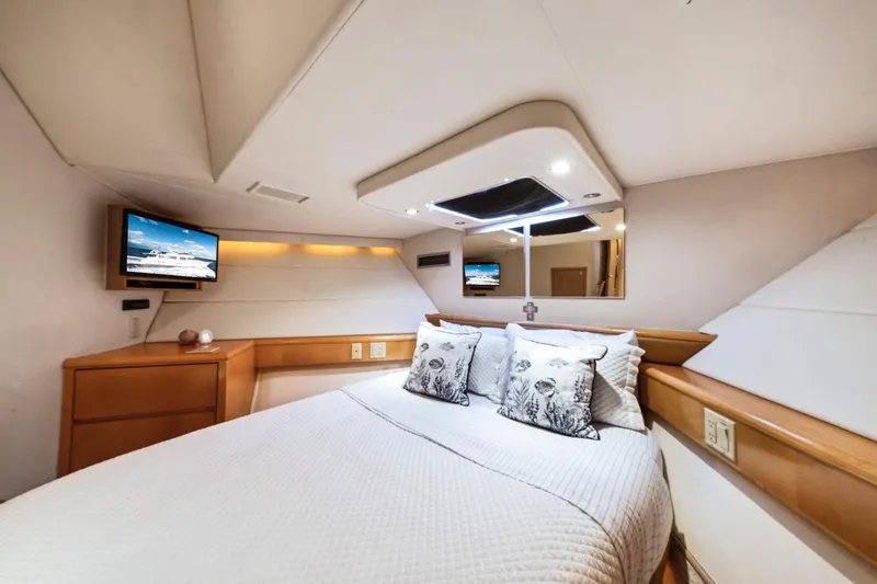Slide: The Image of Luxurious bedroom interior of 2000 Hatteras 74 Cockpit Motor Yacht with modern amenities. - 46