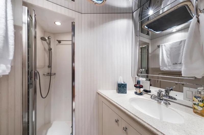 Slide: The Image of Luxurious bathroom in 2000 Hatteras 74 Cockpit Motor Yacht with shower and vanity. - 48