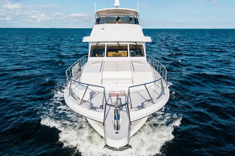 Slide: The Image of Hatteras 74 Cockpit Motor Yacht 2000 cruising on open sea under clear skies. - 5