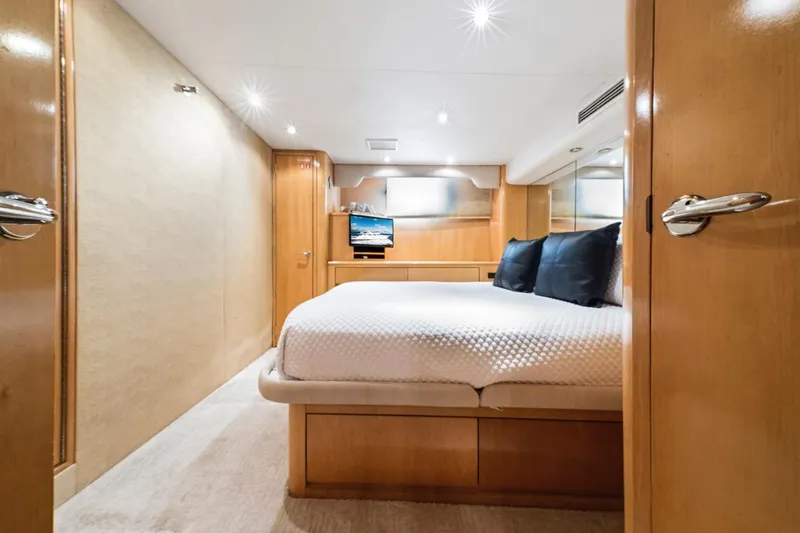 Slide: The Image of Luxurious bedroom interior of 2000 Hatteras 74 Cockpit Motor Yacht with modern amenities. - 52