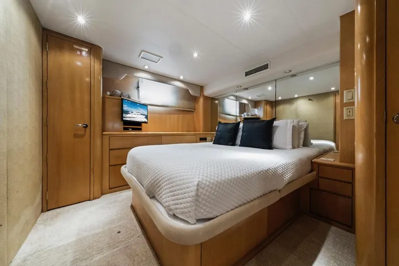 Slide: The Image of Luxurious bedroom interior of 2000 Hatteras 74 Cockpit Motor Yacht with modern amenities. - 53