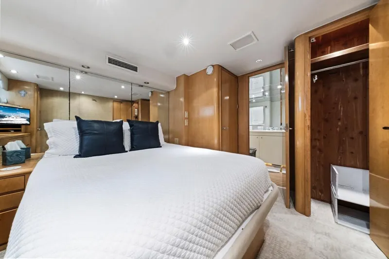 Slide: The Image of Luxurious bedroom interior of 2000 Hatteras 74 Cockpit Motor Yacht with modern amenities. - 54