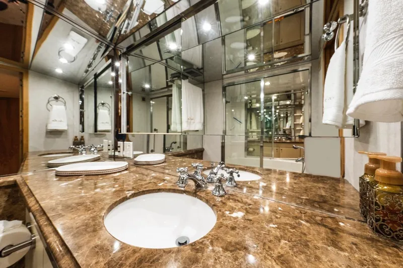 Slide: The Image of Luxurious bathroom in 2000 Hatteras 74 Cockpit Motor Yacht with marble countertop and elegant fixtures. - 58