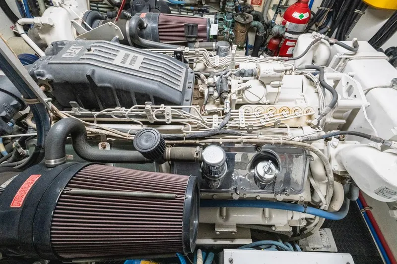 Slide: The Image of Engine room of a 2000 Hatteras 74 Cockpit Motor Yacht, showcasing detailed machinery. - 64