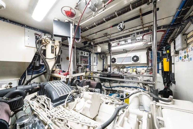 Slide: The Image of Engine room of 2000 Hatteras 74 Cockpit Motor Yacht, showcasing machinery and equipment. - 67