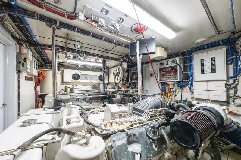 Slide: The Image of Engine room of 2000 Hatteras 74 Cockpit Motor Yacht with complex machinery and wiring. - 68