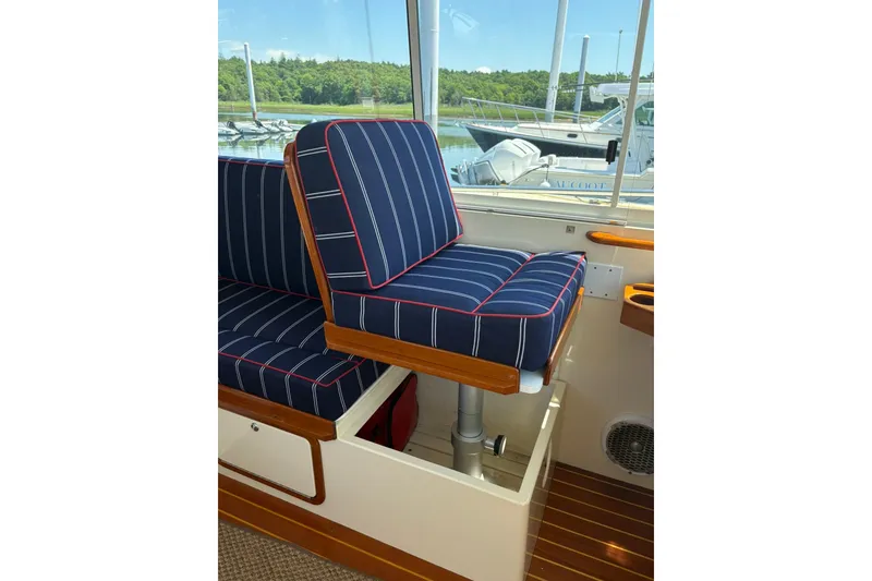 Slide: The Image of Interior of 2004 Bruckmann Bluestar 38 boat with striped seating and wooden accents. - 45