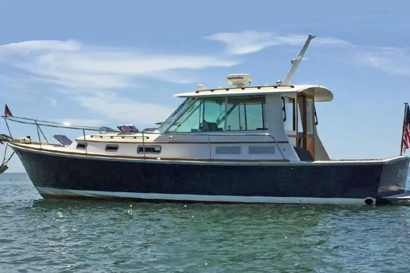 Slide: The Image of 2004 Bruckmann Bluestar 38 boat on calm water under clear sky. - 1