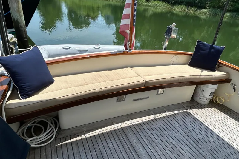Slide: The Image of Cozy seating area on 2004 Bruckmann Bluestar 38 boat with cushions and American flag. - 10