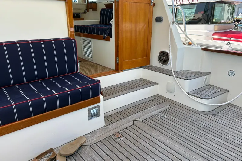 Slide: The Image of Interior of 2004 Bruckmann Bluestar 38 yacht with striped seating and wooden steps. - 53