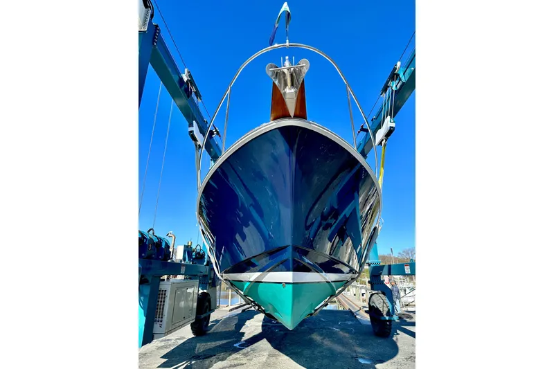 Slide: The Image of 2004 Bruckmann Bluestar 38 boat in dry dock, viewed from the front under a clear blue sky. - 13